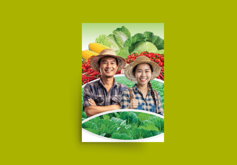 Smiling man and woman in straw hats holding a tray of leafy greens outdoors