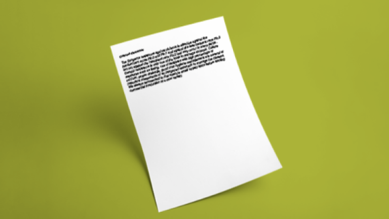 White sheet of paper with text on a green background