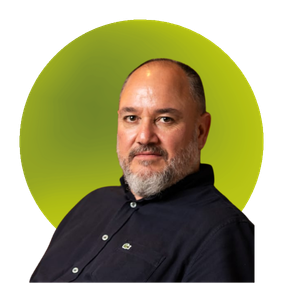Portrait photo of a bearded man in a dark shirt on a green circular background